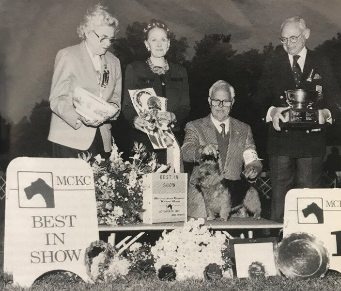 Ch. Chidley Willum The Conqueror, bred by Karen Anderson and owned by Ruth Cooper and Patricia Lussier, is shown winning BIS at Montgomery County in 1993. Pictured are Show Chair Dr. Josephine Deubler, BIS Judge Sandra Goose Allen, Handler Peter Green, and MCKC President Walter Goodman. photo by Ashbey.