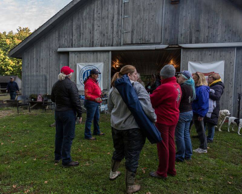 group of people in front of a barn at the 2022 national earthdog test