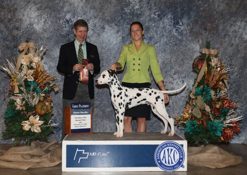 Amanda Gill with her Dalmatian at a dog show podium