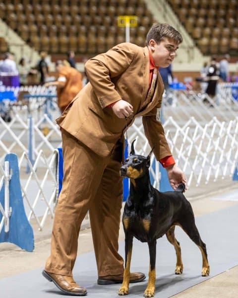Bryant Janetzke with his Doberman Pinscher at a dog show