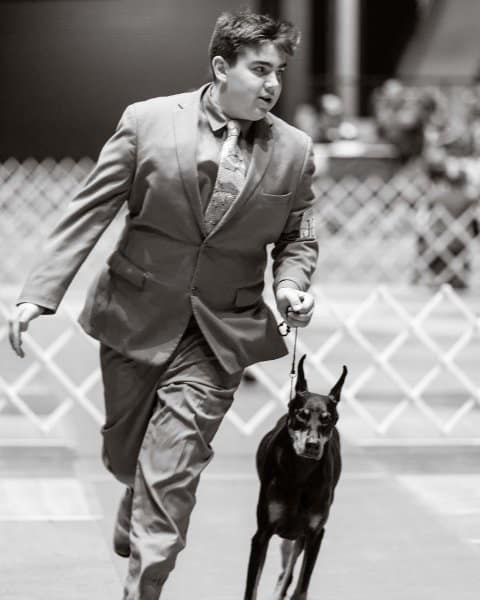 Bryant Janetzke with his Doberman Pinscher at a dog show