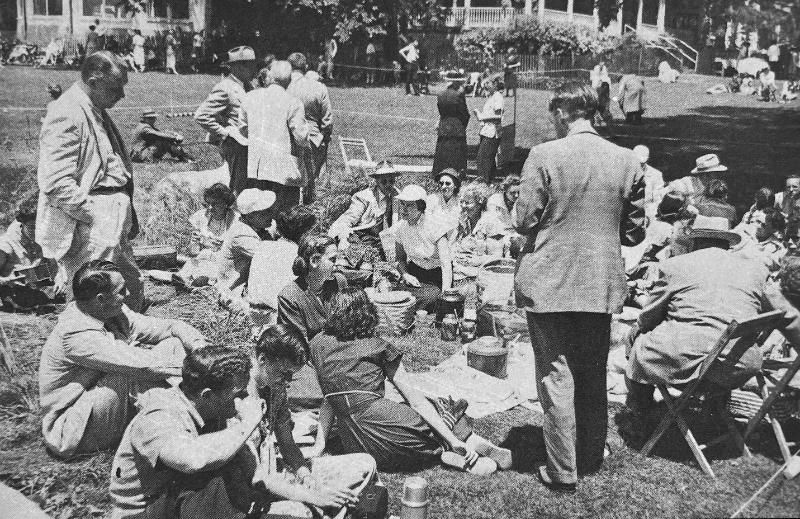 Black and white photo of people having a lunch at a dog show
