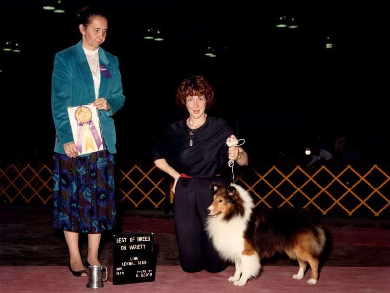 Sulie Greendale-Paveza holding a dog and a medal.